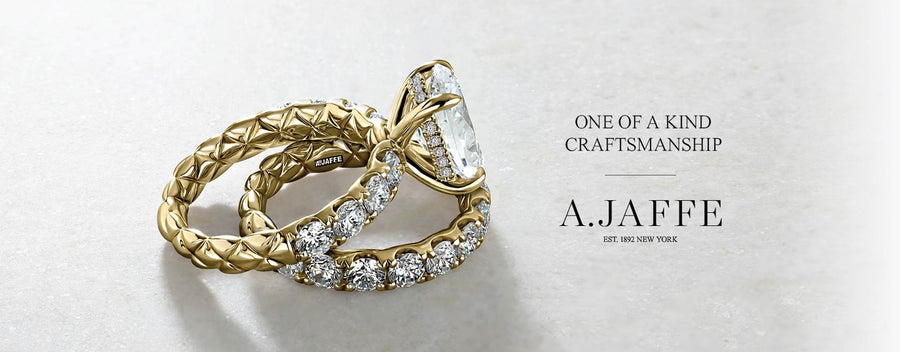 Gold ring with diamonds on a light gray background, featuring A.Jaffe branding.