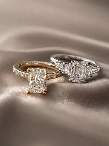 Two diamond rings on a textured beige surface