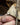 Diamond ring on a finger with a rock background